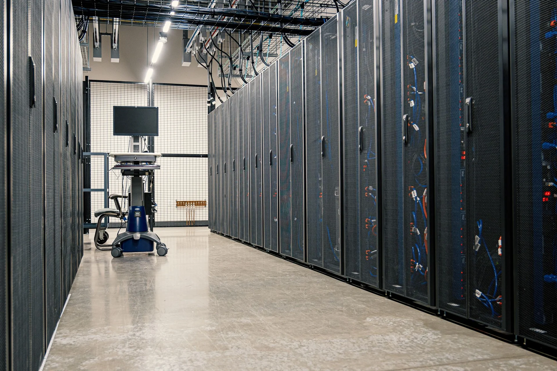 Server cabinets and networking equipment in a data-center aisle